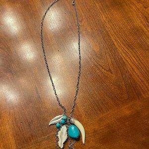 Long silver toned necklace adorned with unusual items!!!